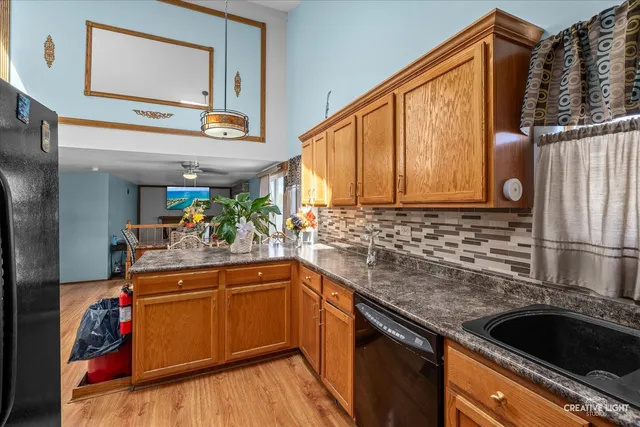 a kitchen with stainless steel appliances granite countertop a sink and a microwave
