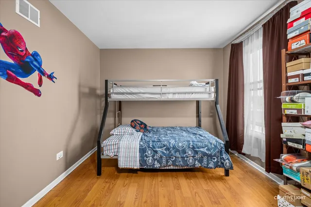 a bedroom with a bed and a book shelf