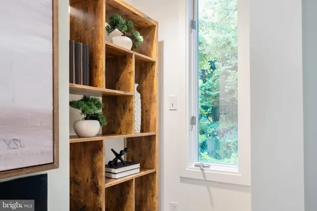 a living room with furniture a table and next to a window