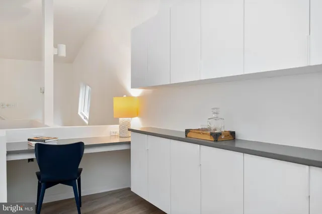 a living room with furniture and painting on the wall