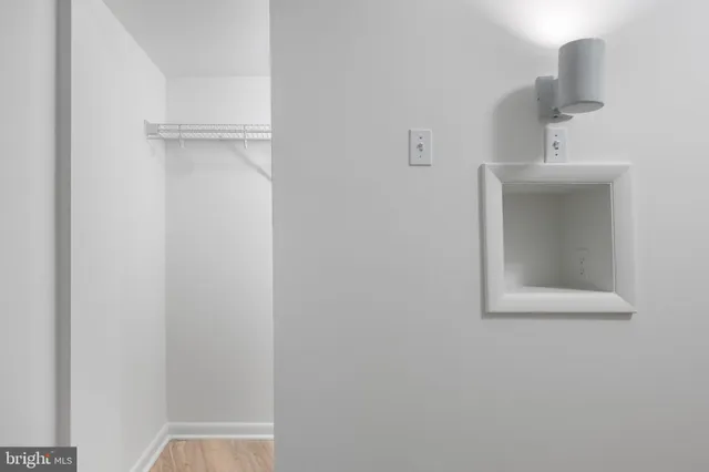 a view of walk in closet with empty racks