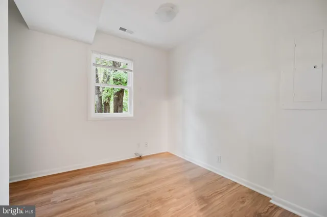 a backyard of a house with barbeque oven and outdoor seating