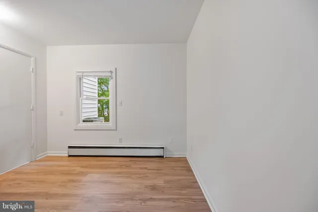 a bench sitting in a room next to a window
