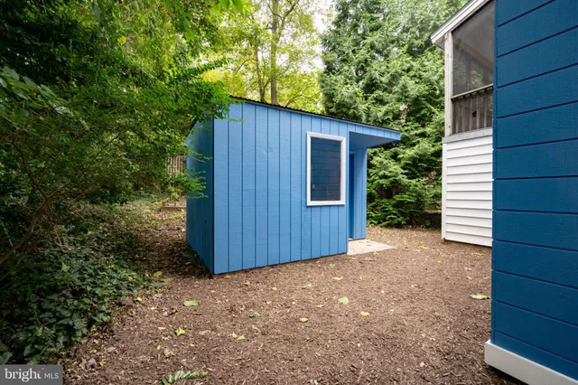 a view of a house with a door and wooden walls