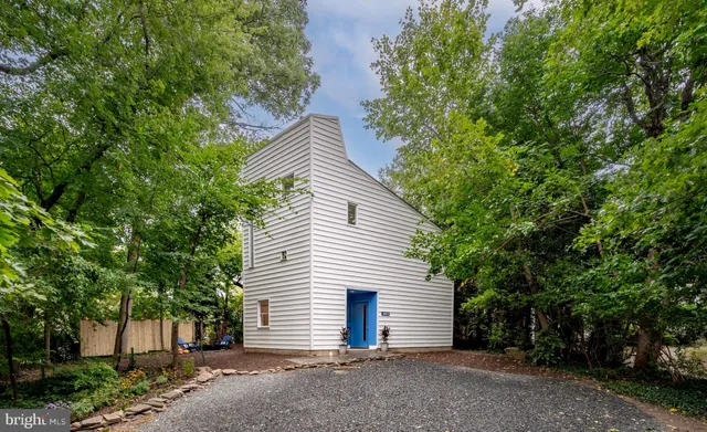 a backyard of a house with barbeque oven table and chairs