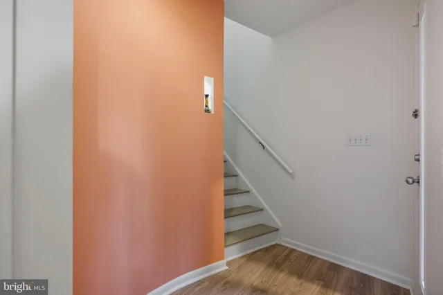 a view of entryway with stairs and wooden floor
