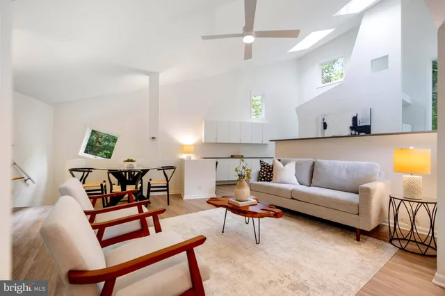 a living room with furniture and a mirror