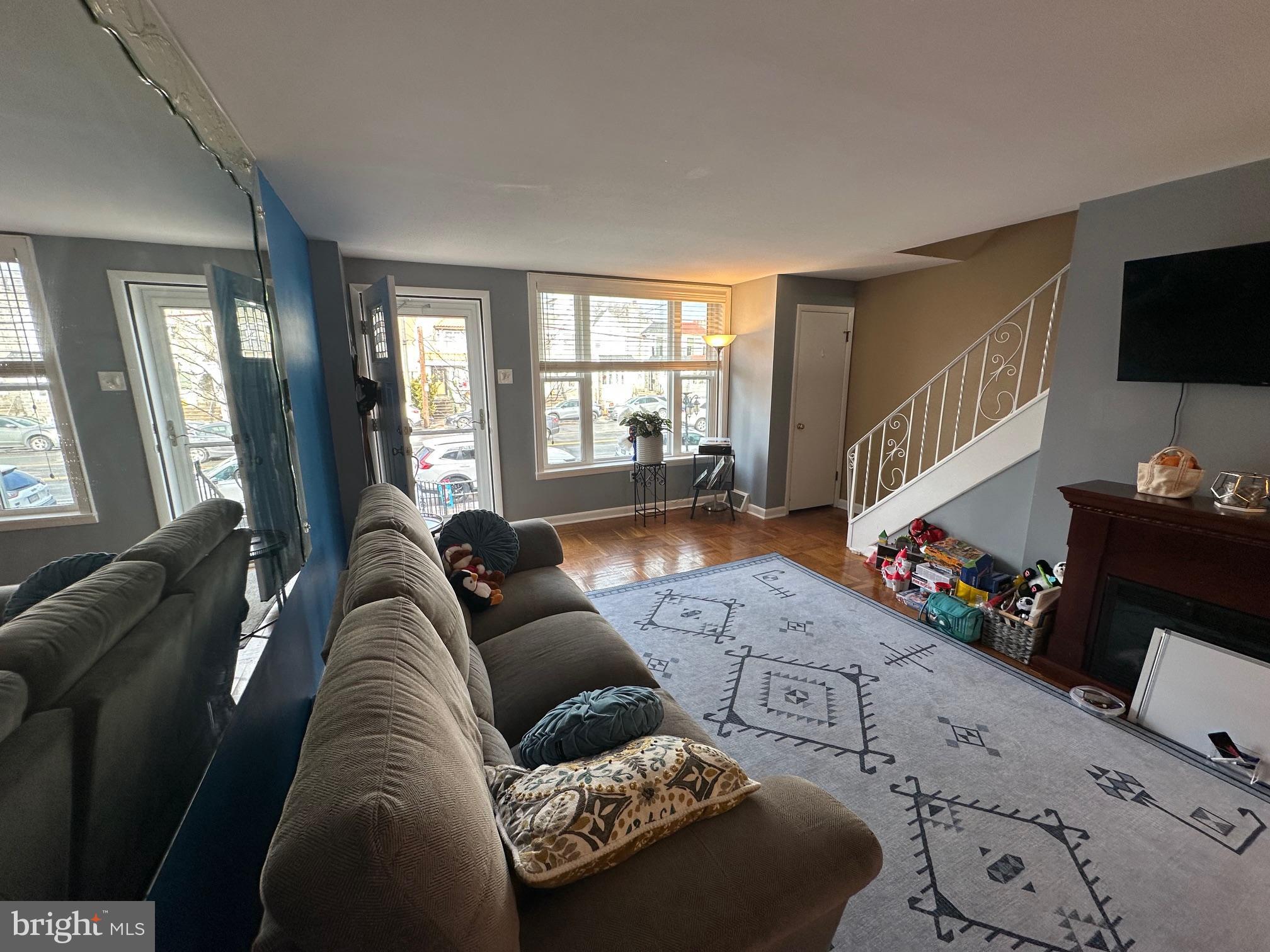 1818 Packer Avenue Philadelphia, PA 19145 - Photo 11 of 23 a living room with furniture and a flat screen tv
