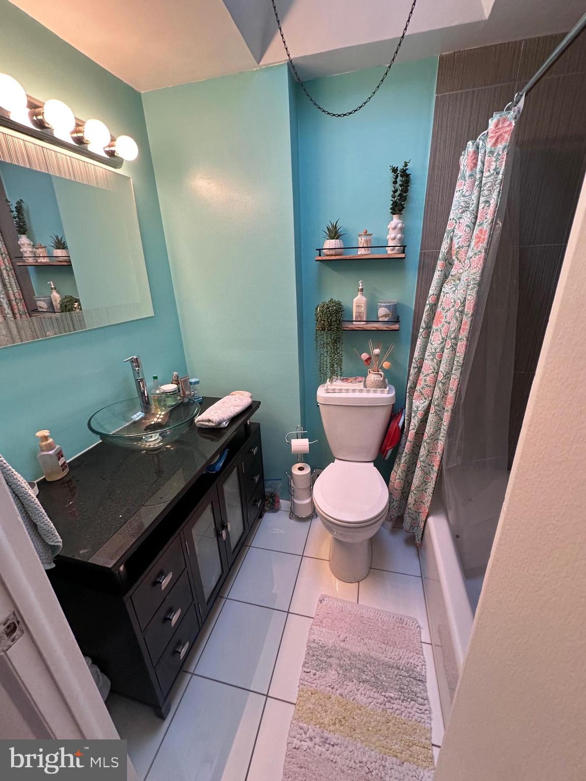 1818 Packer Avenue Philadelphia, PA 19145 - Photo 13 of 23 a bathroom with a sink a toilet and a mirror