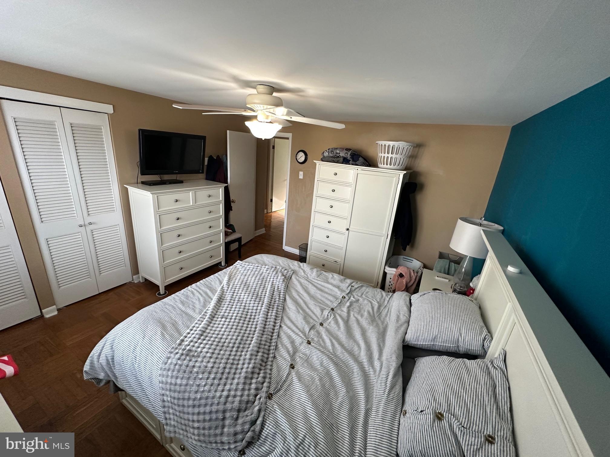 1818 Packer Avenue Philadelphia, PA 19145 - Photo 15 of 23 a bedroom with a bed television with the wooden floor