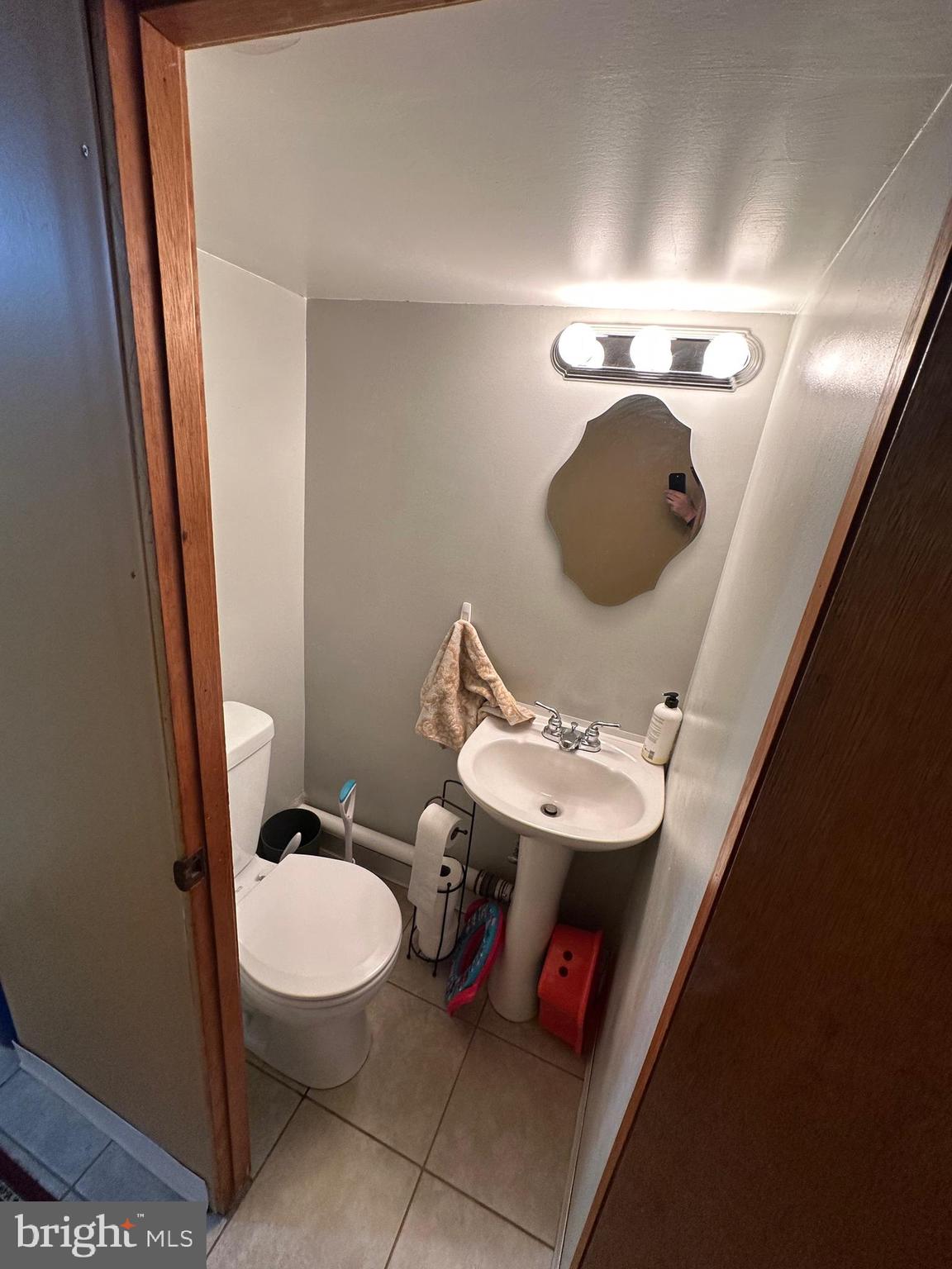 1818 Packer Avenue Philadelphia, PA 19145 - Photo 19 of 23 a bathroom with a toilet sink and mirror