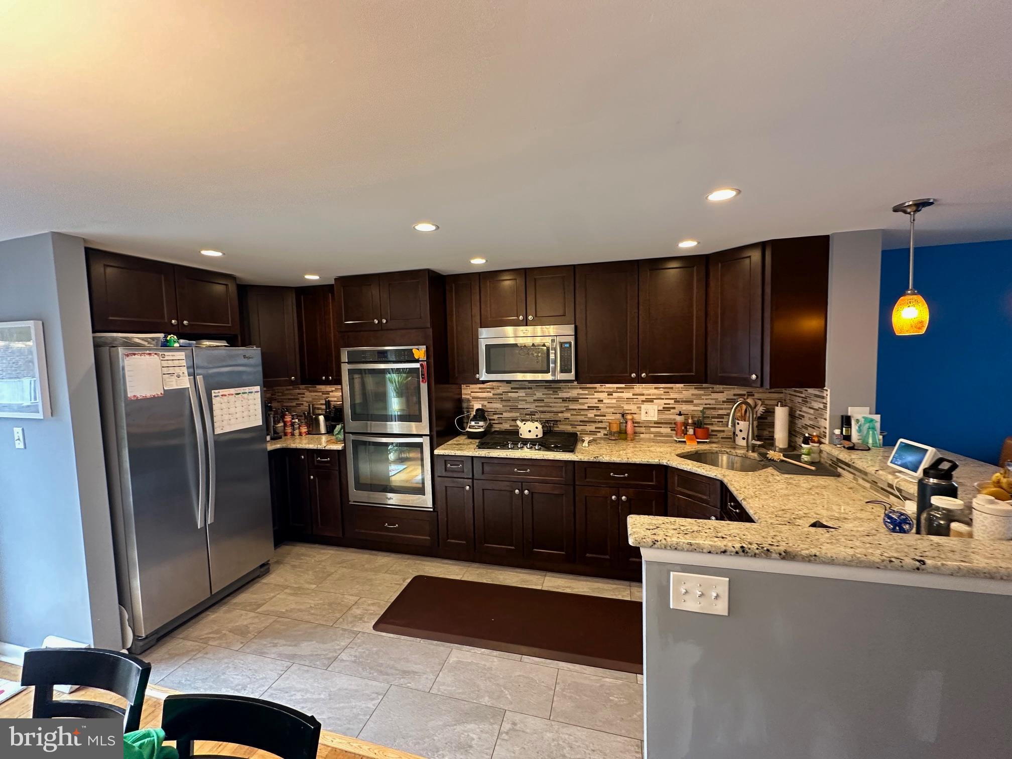 1818 Packer Avenue Philadelphia, PA 19145 - Photo 4 of 23 a kitchen with refrigerator and microwave