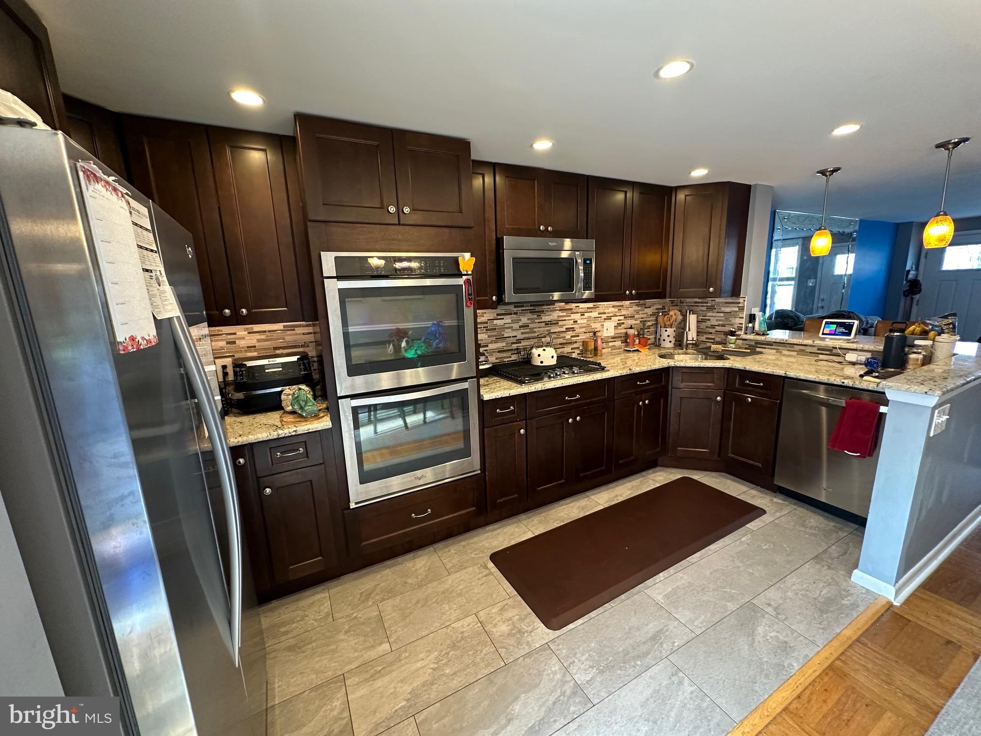 1818 Packer Avenue Philadelphia, PA 19145 - Photo 5 of 23 a kitchen with stainless steel appliances granite countertop a stove refrigerator and cabinets