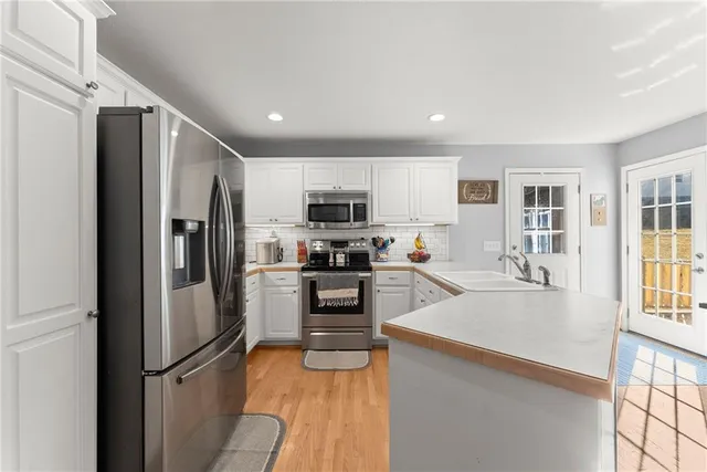 a bedroom with a bed furniture and a flat screen tv