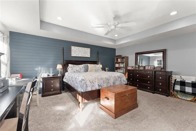 a bedroom with two beds and a painting on the wall