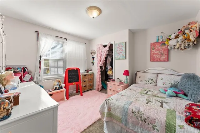 a view of walk in closet with clothes