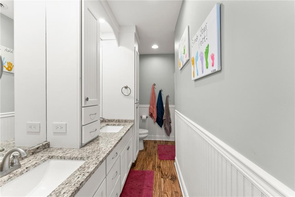 125 Rainbow Circle Cleveland, GA 30528 - Photo 27 of 83 a bathroom with a granite countertop double vanity sink and a mirror