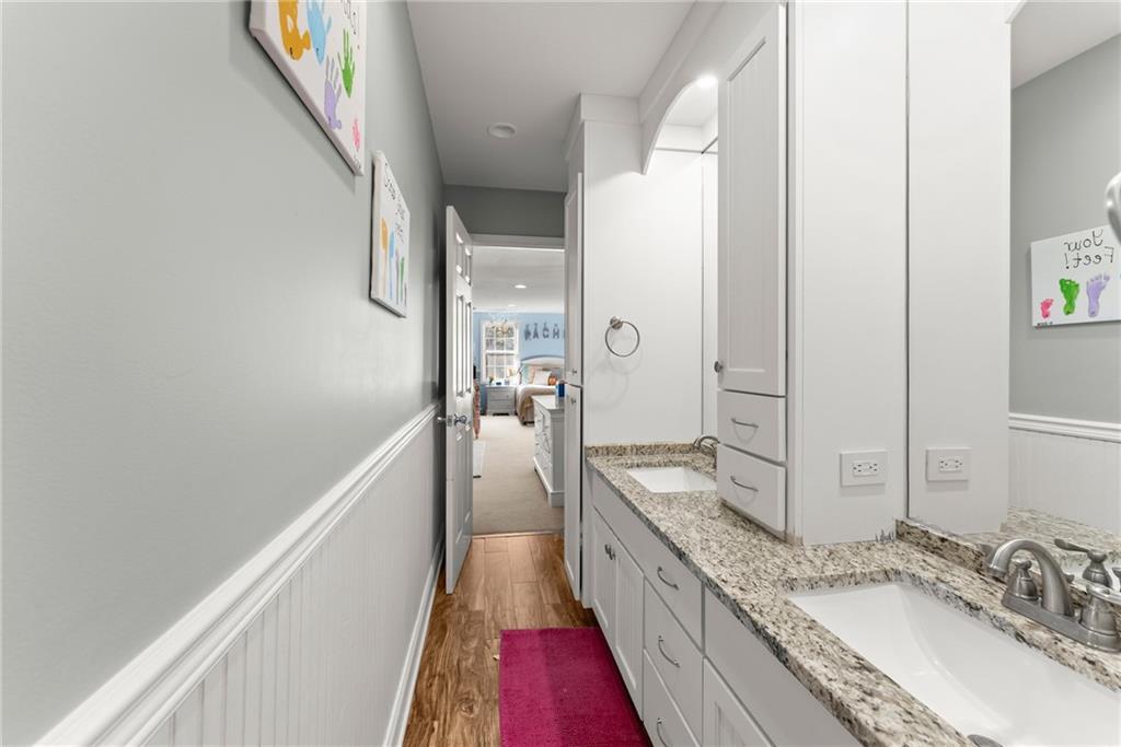 125 Rainbow Circle Cleveland, GA 30528 - Photo 28 of 83 a bathroom with a granite countertop double vanity sink and mirror