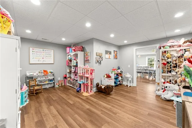 a kitchen with stainless steel appliances granite countertop a refrigerator a stove a sink a dining table and chairs