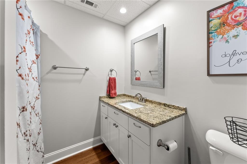 125 Rainbow Circle Cleveland, GA 30528 - Photo 35 of 83 a bathroom with a granite countertop sink and a mirror
