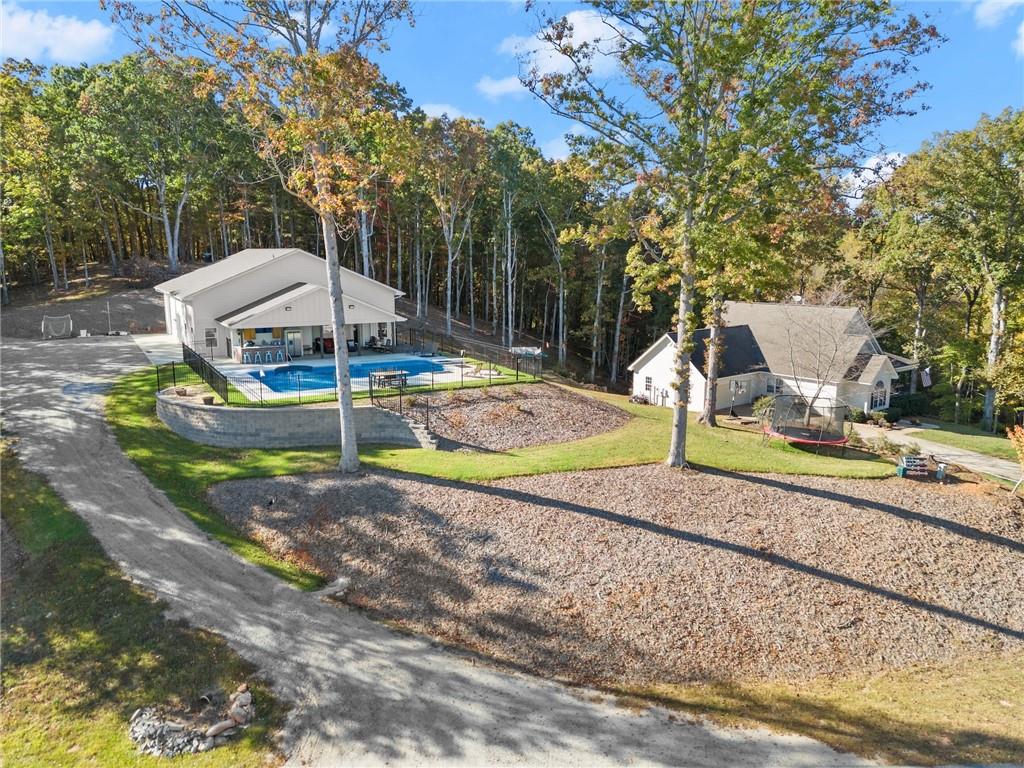 125 Rainbow Circle Cleveland, GA 30528 - Photo 38 of 83 a view of a backyard with table and chairs under an umbrella