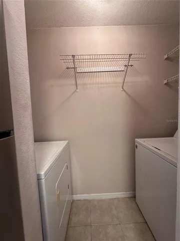 a view of a storage and utility room with racks on the wall