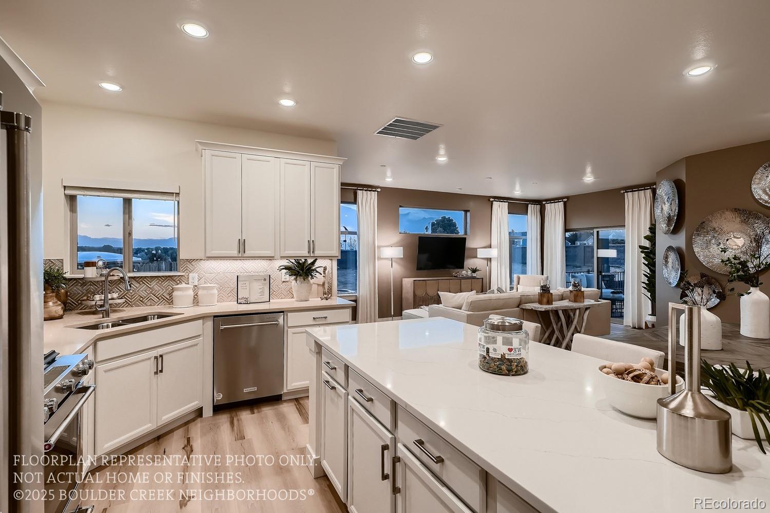 a kitchen with counter top space sink stove and cabinets