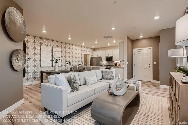 a view of kitchen with kitchen island stainless steel appliances wooden floor and living room view