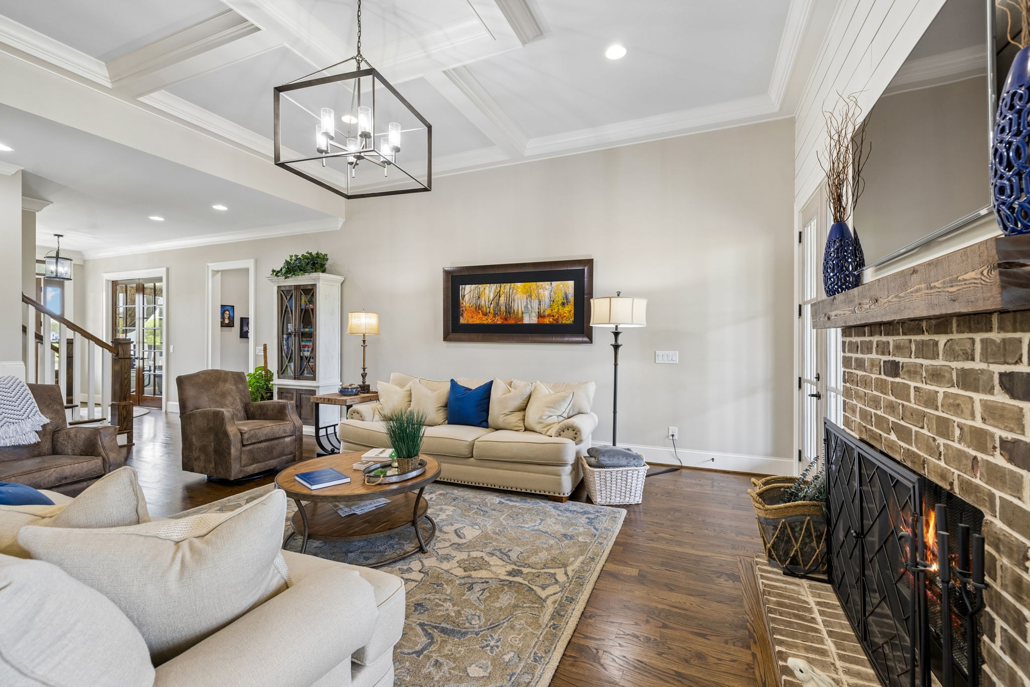 6033 Native Pony Trail College Grove, TN 37046 - Photo 22 of 87 a living room with furniture a fireplace and a chandelier