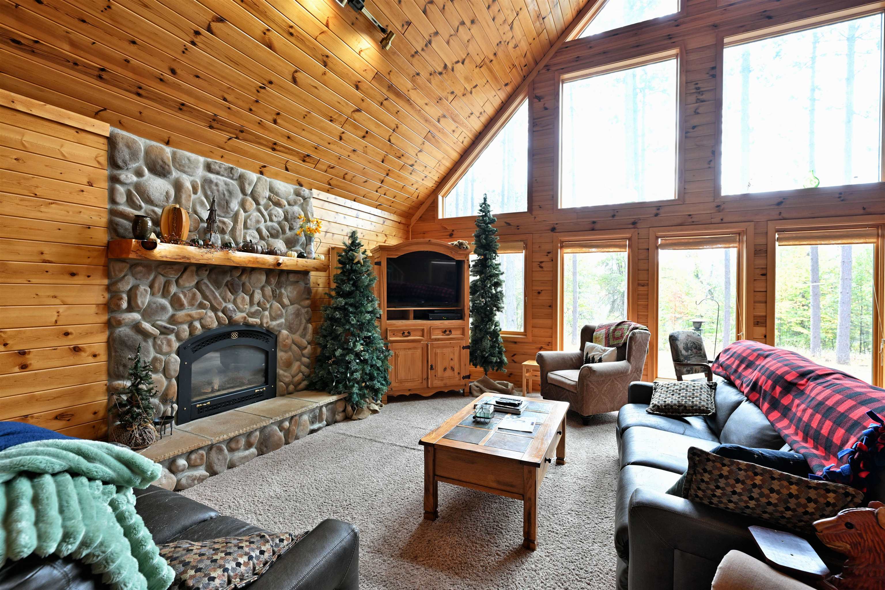13672 East Short Road Gordon, WI 54838 - Photo 47 of 75 Living room with wood walls, high vaulted ceiling, a fireplace, carpet floors, and wooden ceiling
