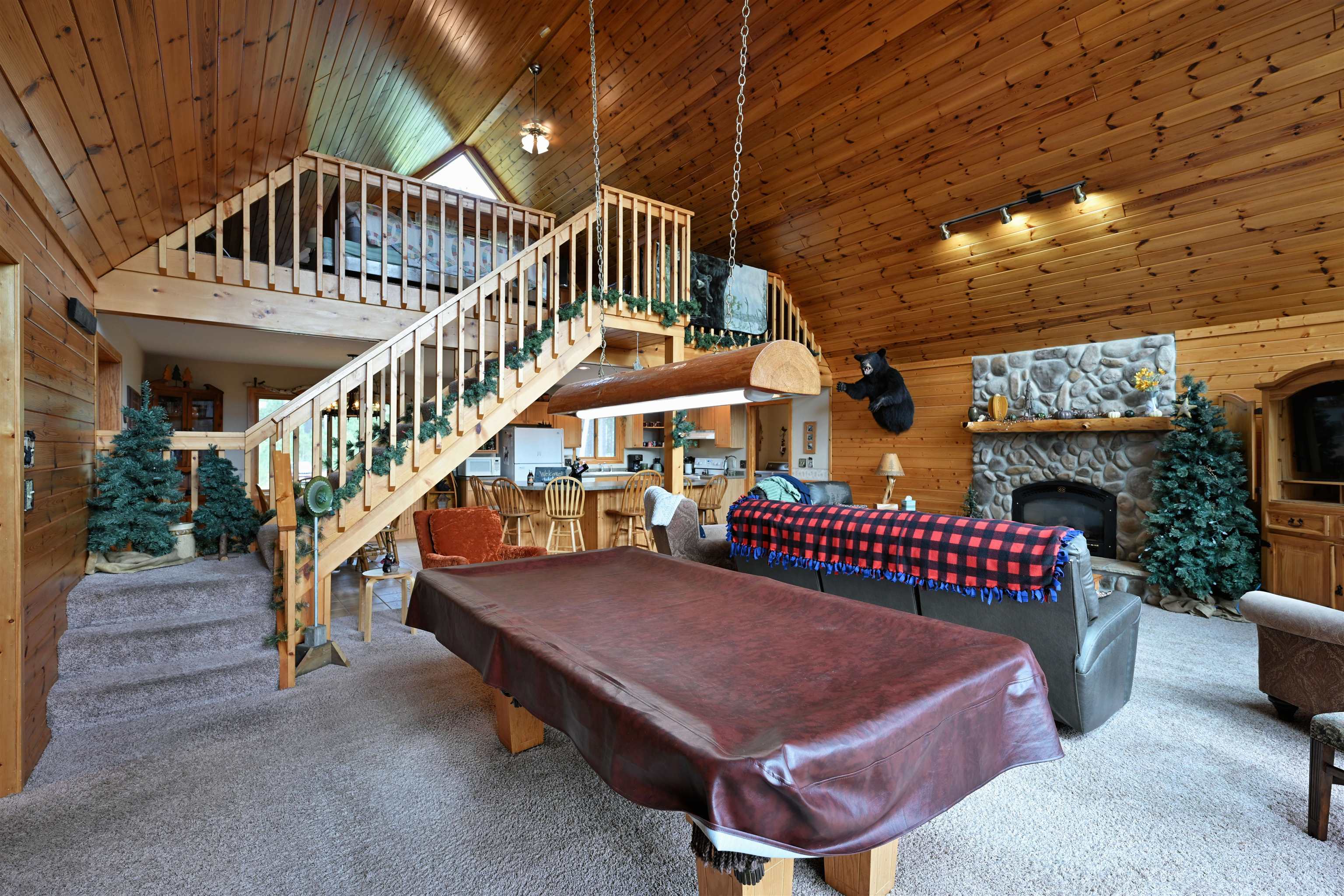 13672 East Short Road Gordon, WI 54838 - Photo 54 of 75 Playroom with wood walls, high vaulted ceiling, carpet, wooden ceiling, and a fireplace