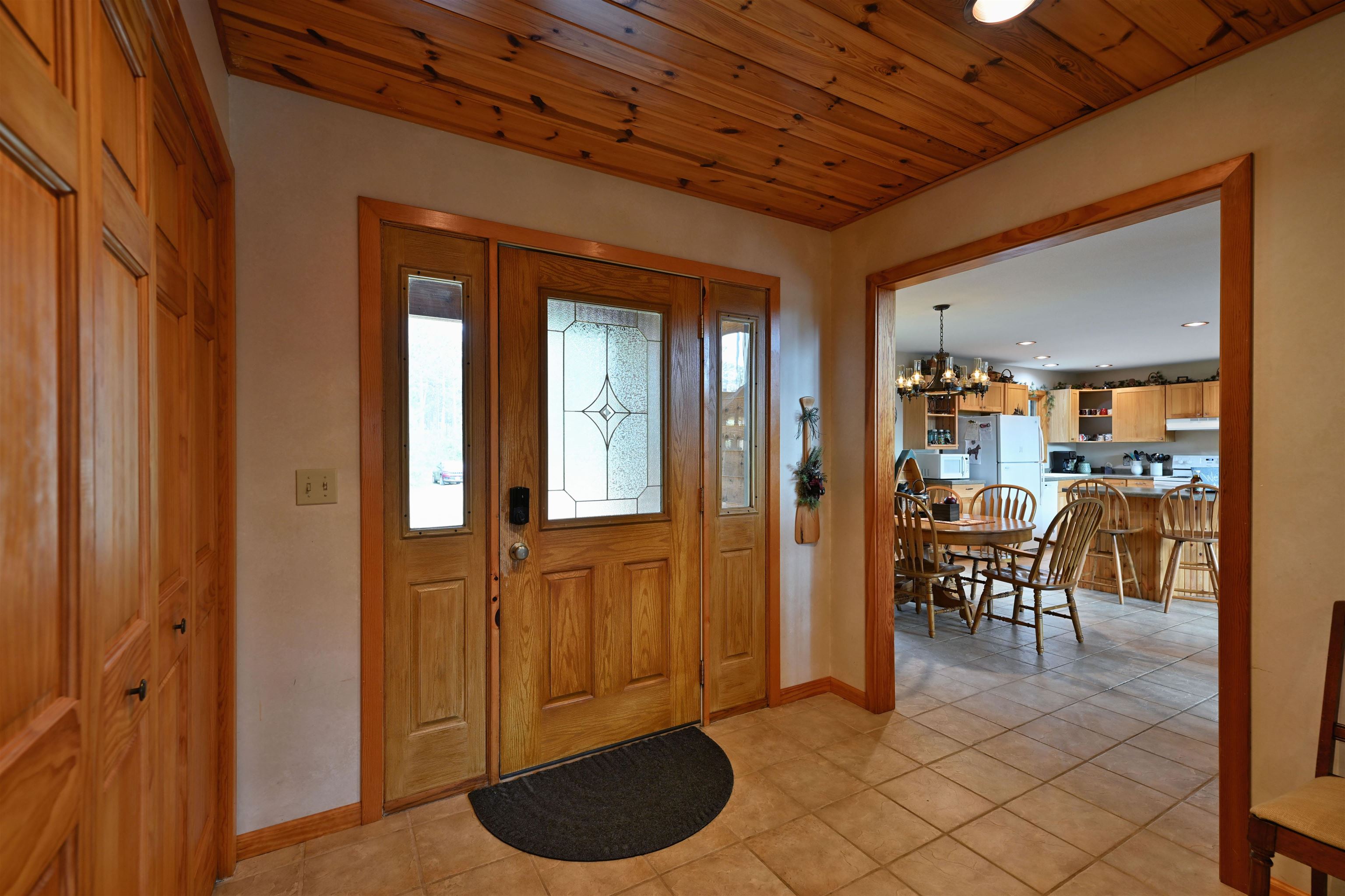 13672 East Short Road Gordon, WI 54838 - Photo 57 of 75 Entrance foyer featuring a chandelier, light tile patterned flooring, wooden ceiling, and recessed lighting