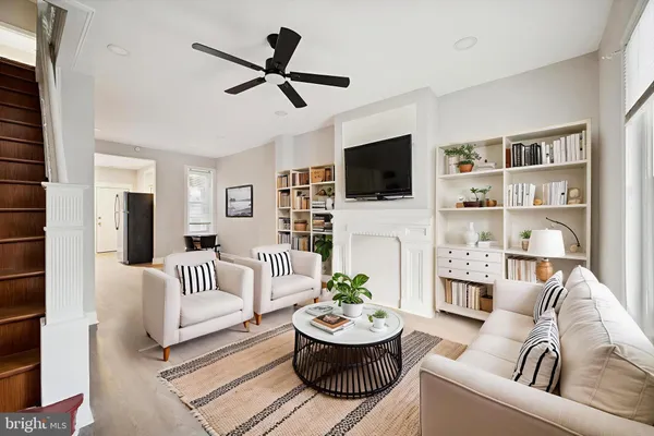 a living room with furniture a fireplace and a flat screen tv