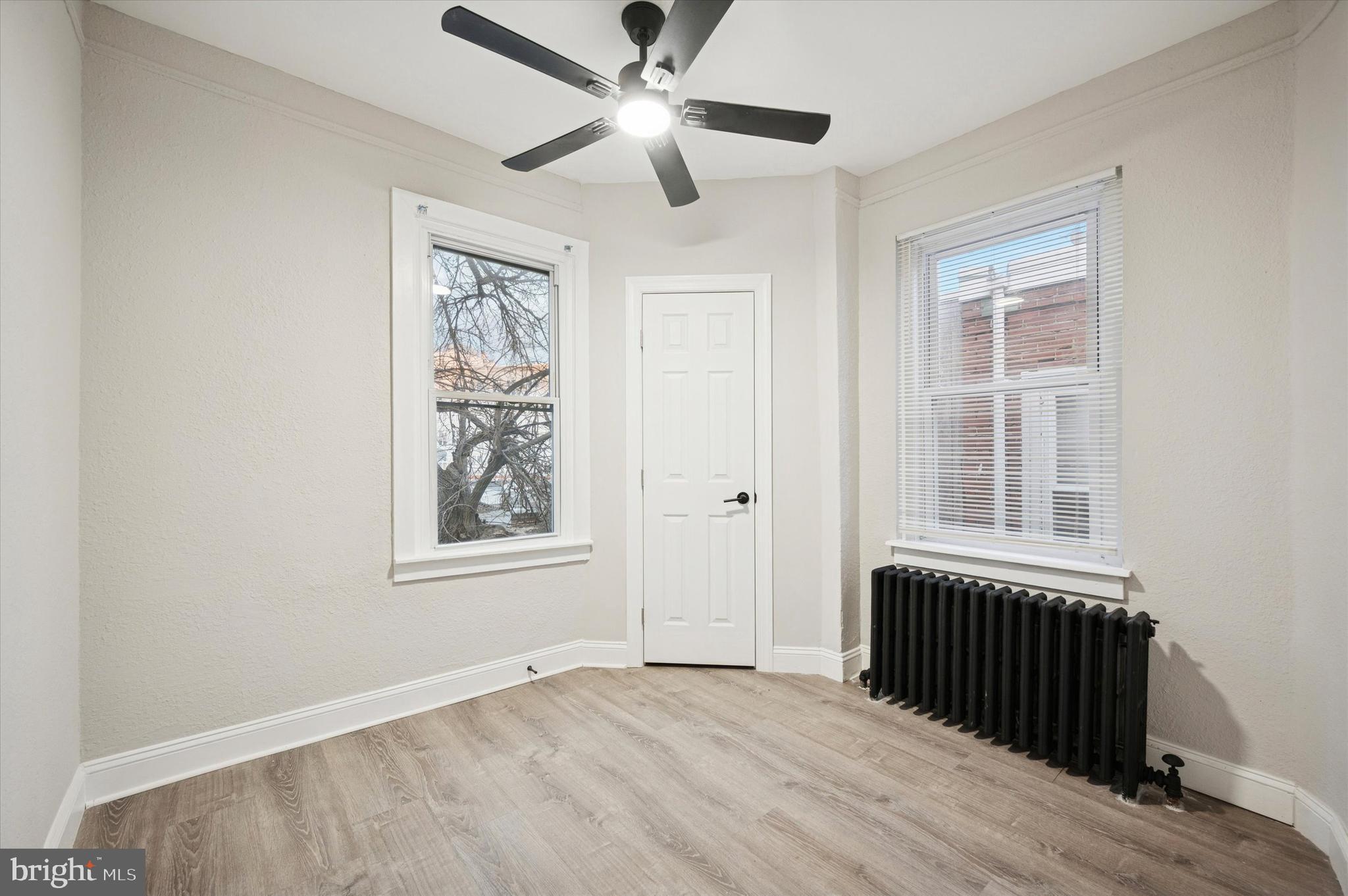 5517 Jane Street Philadelphia, PA 19138 - Photo 11 of 19 an empty room with wooden floor ceiling fan and windows