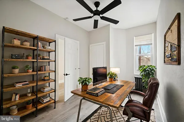 a view of a workspace with furniture and a potted plant