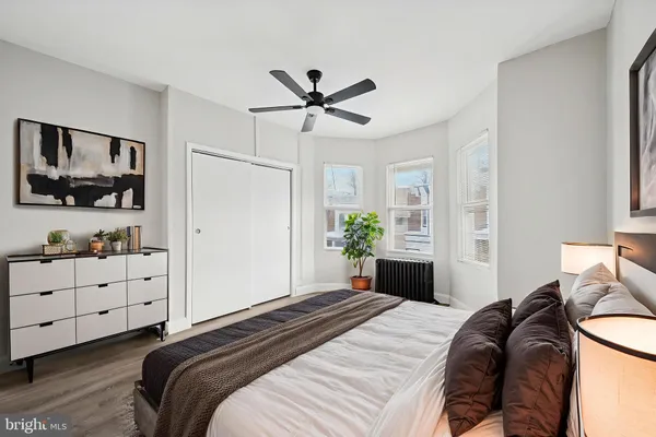 a bedroom that has a bed and a chandelier