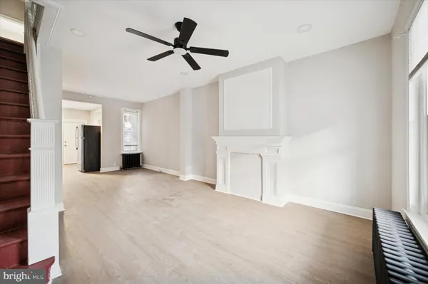 a view of empty room with ceiling fan