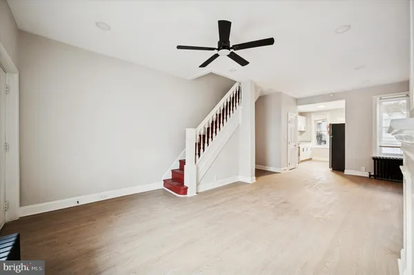 a view of a livingroom with a ceiling fan and entryway