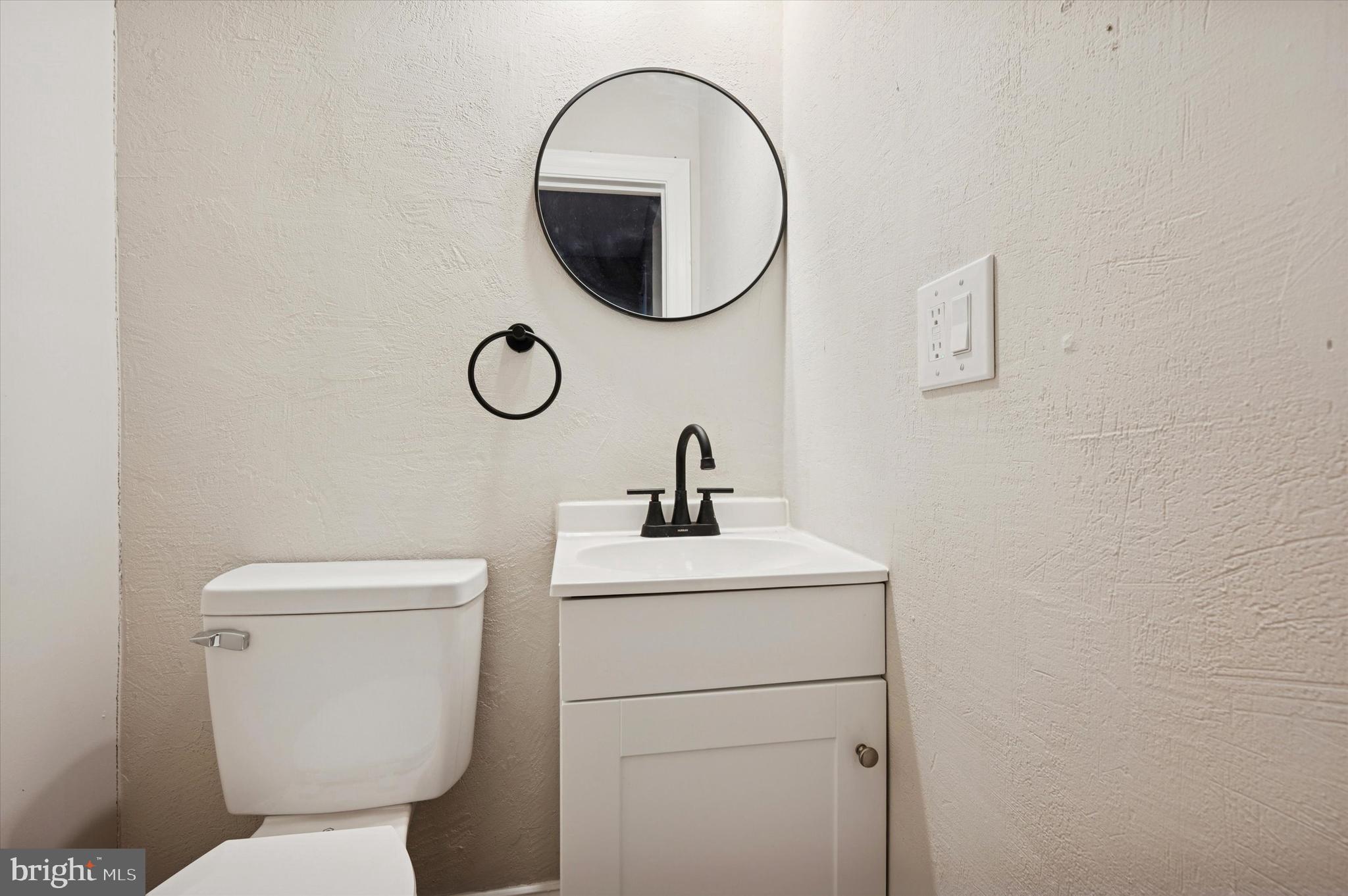5517 Jane Street Philadelphia, PA 19138 - Photo 9 of 19 a bathroom with a toilet sink vanity and a mirror