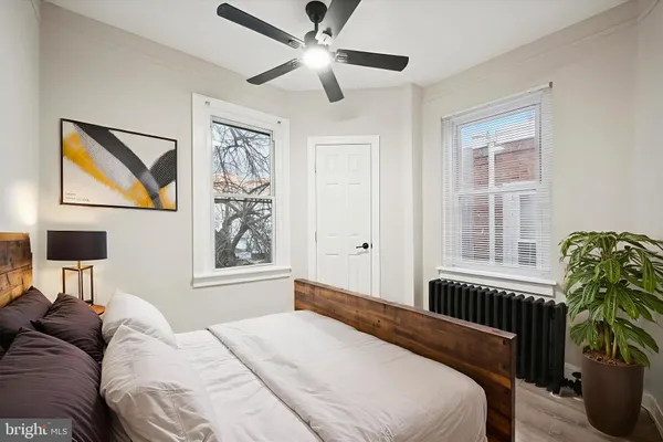 a bedroom with a bed and a window
