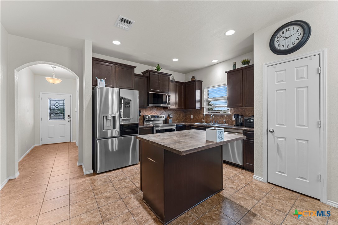 308 Kayla Street Troy, TX 76579 - Photo 18 of 32 a kitchen with stainless steel appliances granite countertop a refrigerator a stove and a sink