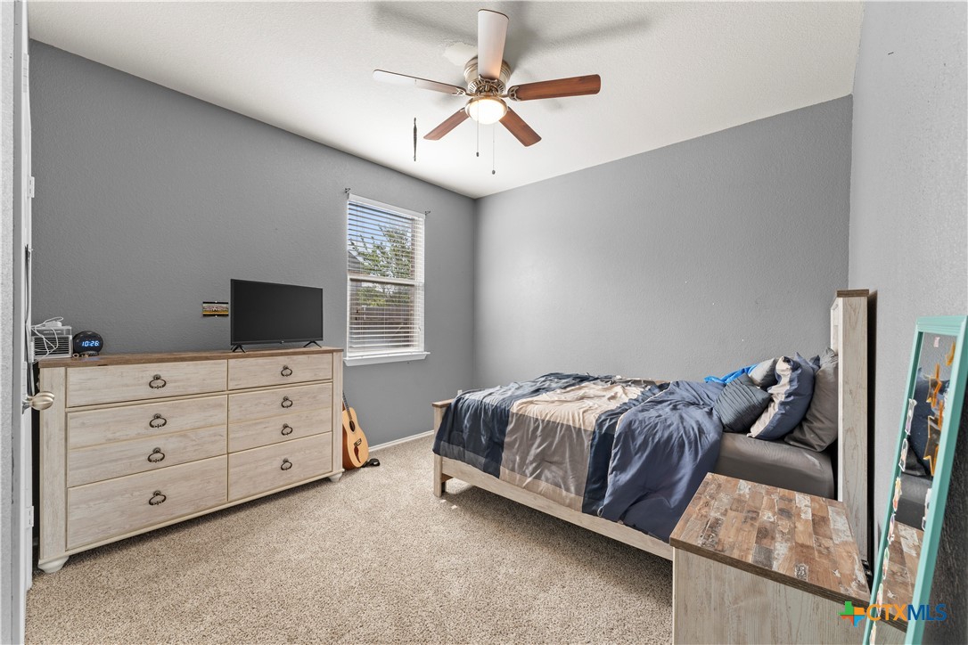 308 Kayla Street Troy, TX 76579 - Photo 23 of 32 a bedroom with a bed a window and a flat screen tv