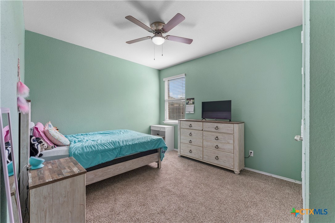 308 Kayla Street Troy, TX 76579 - Photo 26 of 32 a bedroom with a bed and a ceiling fan