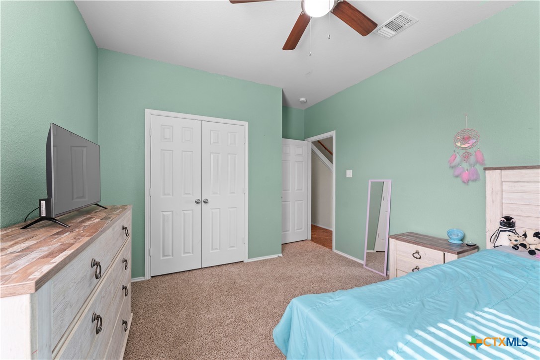 308 Kayla Street Troy, TX 76579 - Photo 27 of 32 a bedroom with a bed and a flat tv screen on dresser