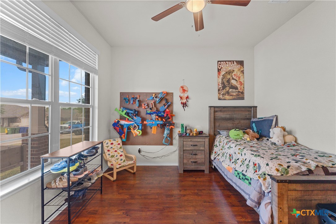 308 Kayla Street Troy, TX 76579 - Photo 28 of 32 a bedroom with a bed and a table in it