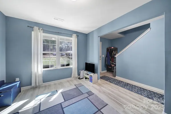 a view of a room with wooden floor and a window