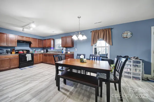 a kitchen with stainless steel appliances granite countertop a stove sink and cabinets