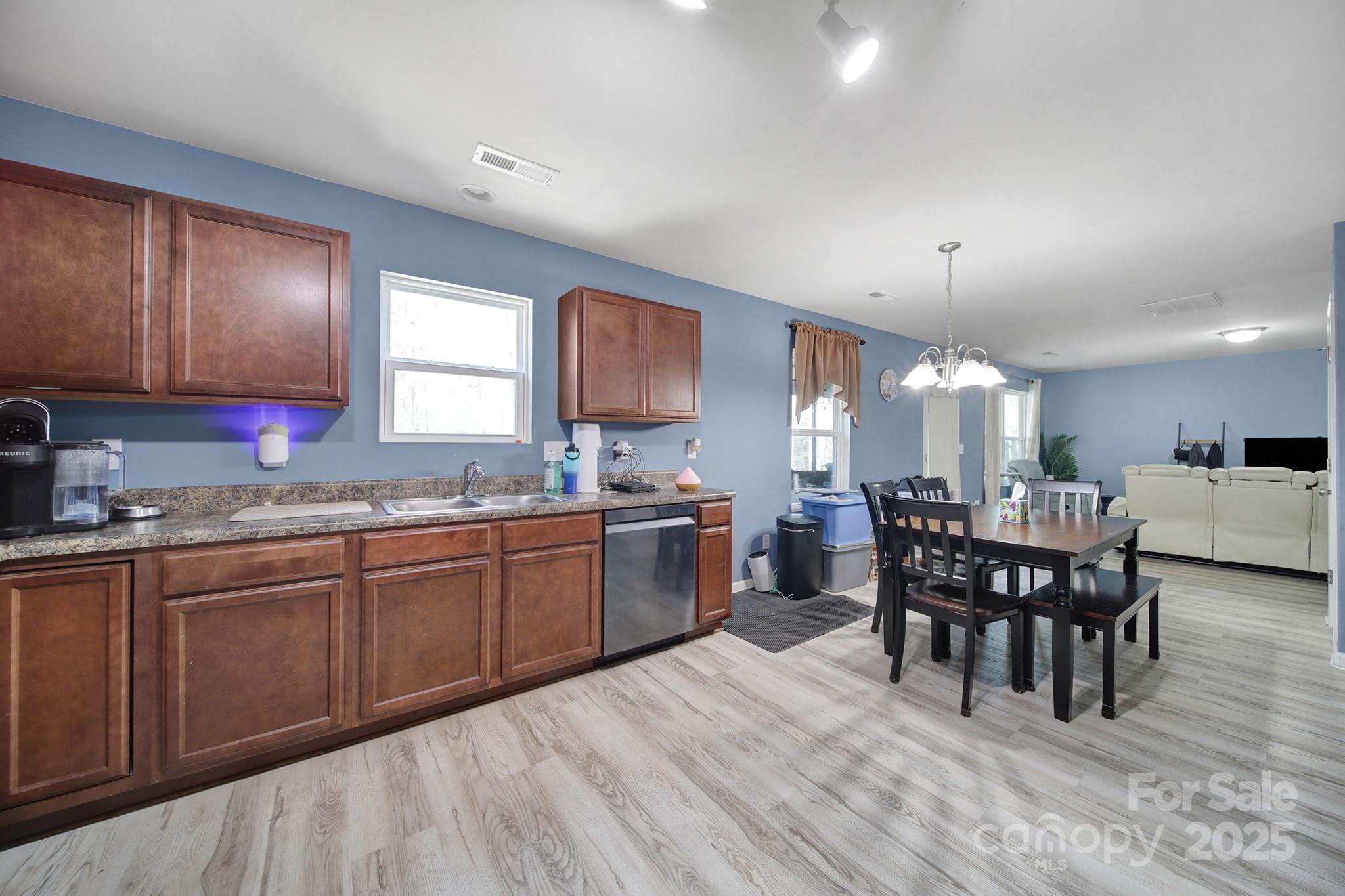 1708 Millwood Road Lancaster, SC 29720 - Photo 24 of 40 a kitchen with a dining table chairs and white cabinets