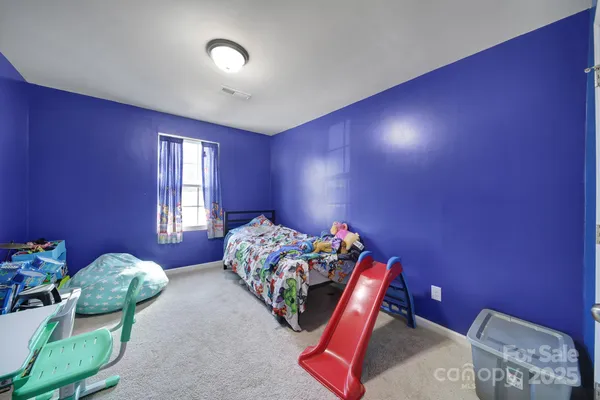 a bedroom with bed and a chandelier