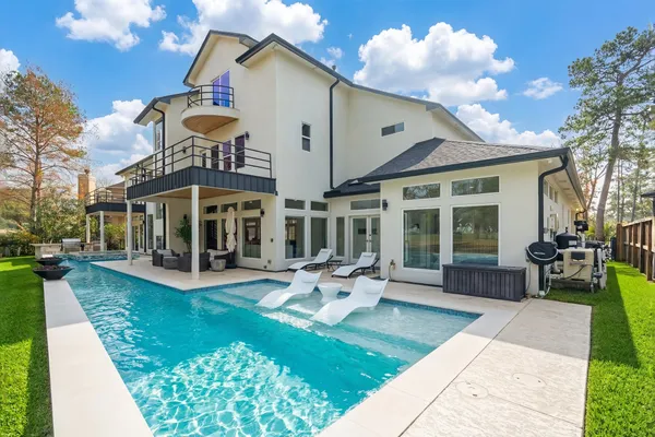 a view of a house with sitting area and garden
